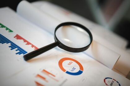 Medical researchers reviewing data charts showing registration requirements across different study types