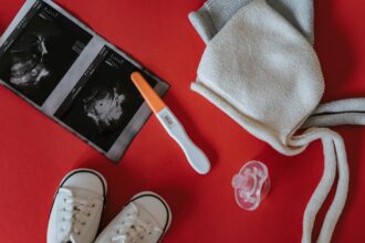 Medical professional performing ultrasound screening on infant for hip dysplasia detection