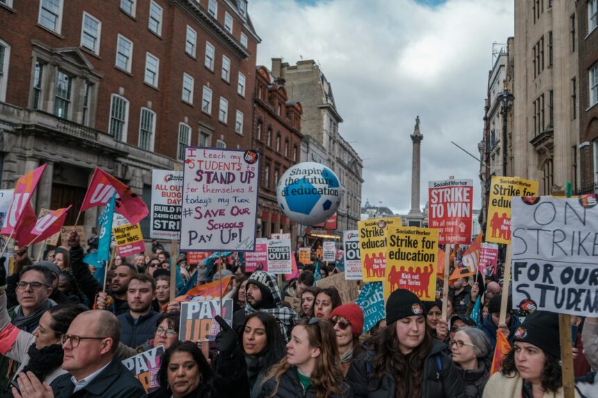 Junior doctors on picket line holding BMA strike banners outside hospital