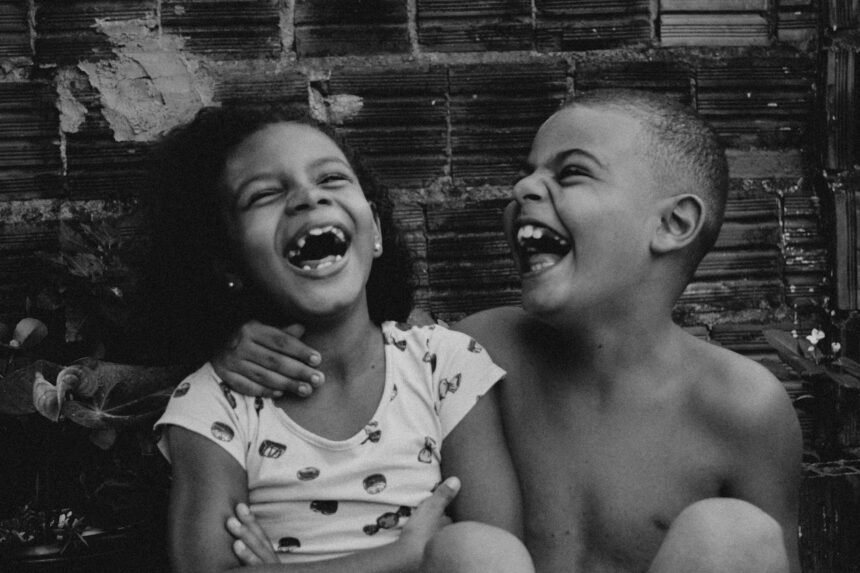 Children laughing during therapeutic play session showing brain development benefits