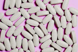 Various magnesium supplement bottles and capsules arranged on laboratory bench