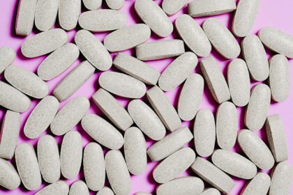 Various magnesium supplement bottles and capsules arranged on laboratory bench