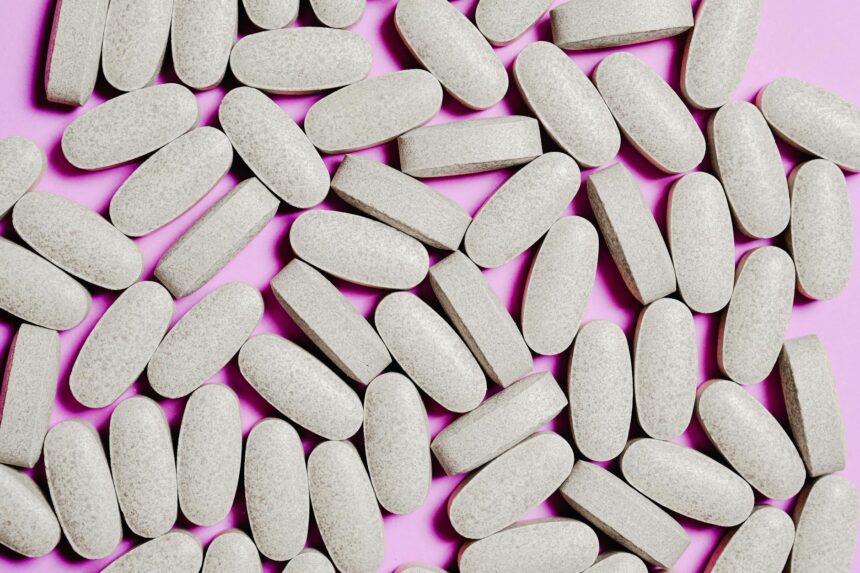 Various magnesium supplement bottles and capsules arranged on laboratory bench
