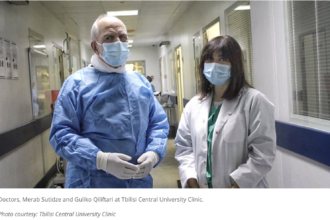 Healthcare professionals working in a hospital corridor in Tbilisi, illustrating the importance of protecting and supporting the health workforce.