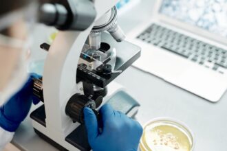 Biotech laboratory researcher working with advanced equipment representing innovation challenges