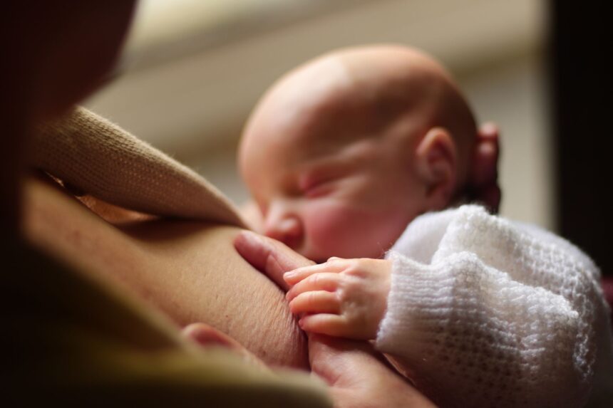 New mother struggling with breastfeeding in hospital setting