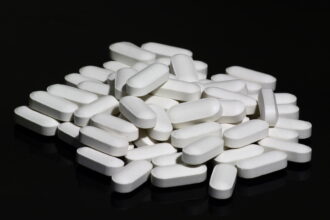 Older adult consulting with healthcare provider about bone health supplementation and fracture prevention strategies