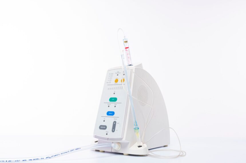 Medical professional inspecting positive pressure breathing device in hospital setting