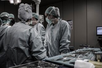 Healthcare professional in clinical setting processing distant conflict trauma