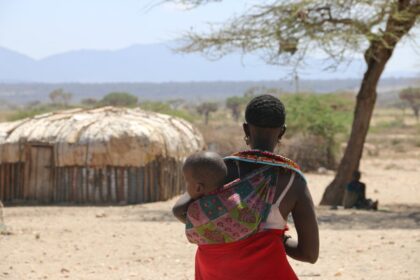 Kenyan mother holding newborn baby representing maternal health challenges after birth complications