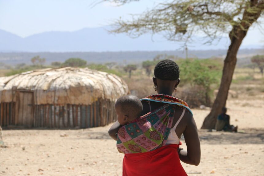 Kenyan mother holding newborn baby representing maternal health challenges after birth complications