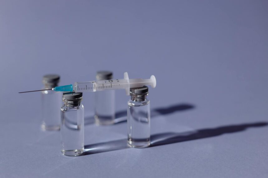 Medical researcher working with vaccine vials in laboratory setting for Lassa fever vaccine development