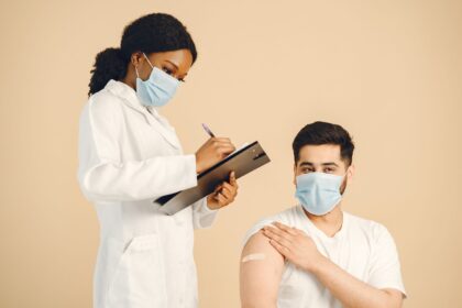 Medical researcher holding vaccine vial in laboratory setting