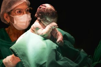 Healthcare providers attending to pregnant women in clinical setting