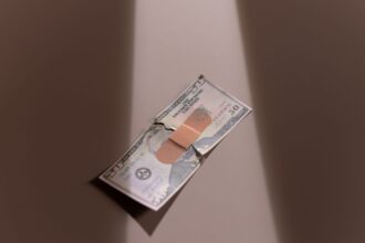 Patient reviewing medical bills and legal documents showing healthcare debt crisis