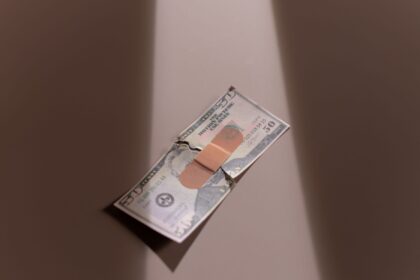 Patient reviewing medical bills and legal documents showing healthcare debt crisis