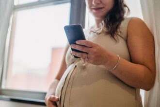 Rural healthcare worker using mobile phone for pregnancy data collection in Bangladesh
