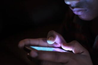 Healthcare worker conducting phone-based mortality survey in rural Bangladesh setting
