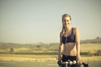 Cyclists exercising on stationary bikes with and without music; heart rate and lactate monitors visible
