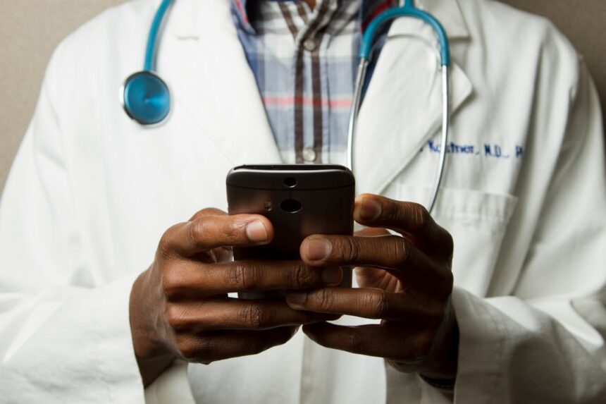 Healthcare worker using mobile app to report medicine safety issues in Nigeria