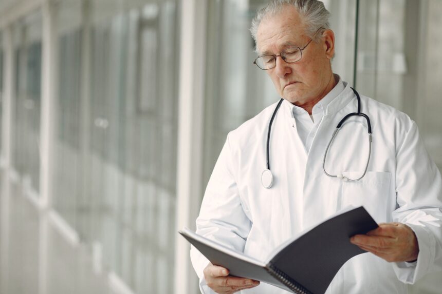 Elderly woman in medical scrubs representing oldest medical resident