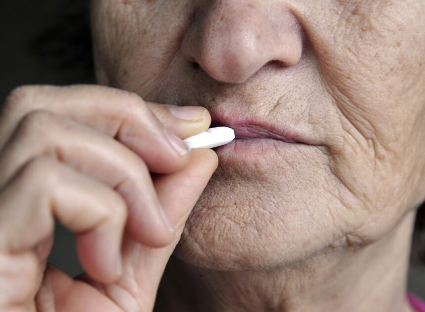 Elderly cancer patient taking oral medication at home instead of receiving IV treatment