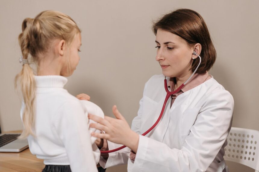 Pediatrician examining child with digital device showing AI interface