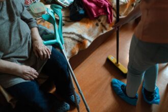 Adult caregiver supporting both child and elderly parent, representing sandwich generation dual caregiving responsibilities