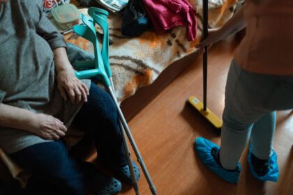 Adult caregiver supporting both child and elderly parent, representing sandwich generation dual caregiving responsibilities