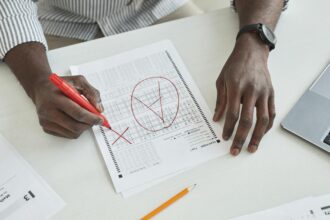 Medical professional administering cognitive assessment test showing Montreal Cognitive Assessment scoring sheet