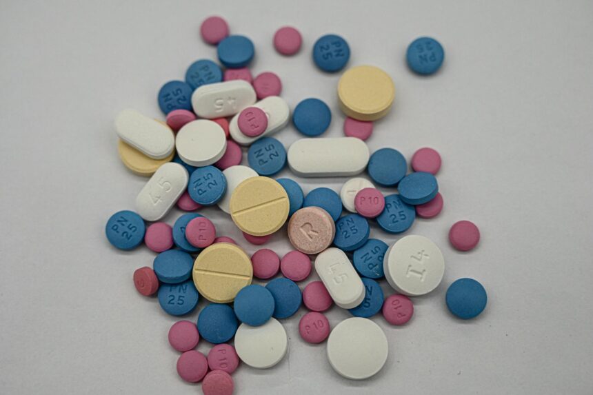 Medical pills and regulatory documents representing UK medicine approvals