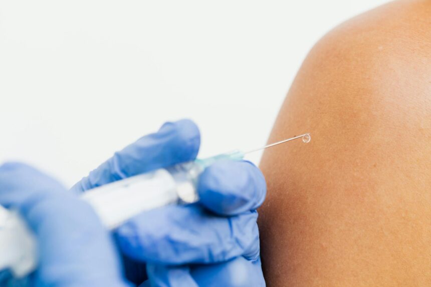 Medical professional preparing enhanced flu vaccine for older adult patient