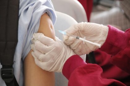 Medical professional preparing 4CMenB vaccine for gonorrhoea prevention programme