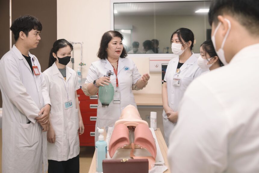 Medical students training in realistic hospital simulation ward with modern equipment