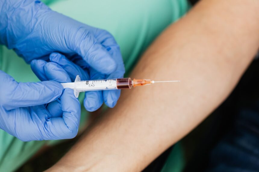 Medical professional handling blood collection equipment in clinical setting