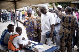 Healthcare workers in Malawi distributing mosquito nets as part of malaria prevention program