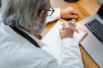 Healthcare professional reviewing AI clinical decision support tool with patient data