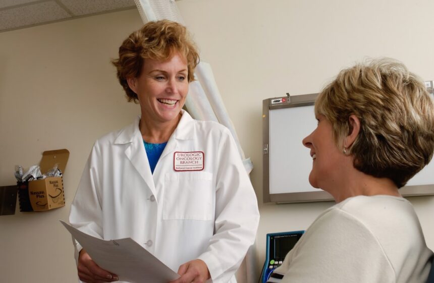 Healthcare professional conducting annual health assessment with woman, representing PCOS screening protocol
