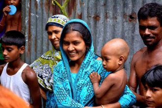 Healthcare workers treating measles patients in a crowded hospital ward in Bangladesh