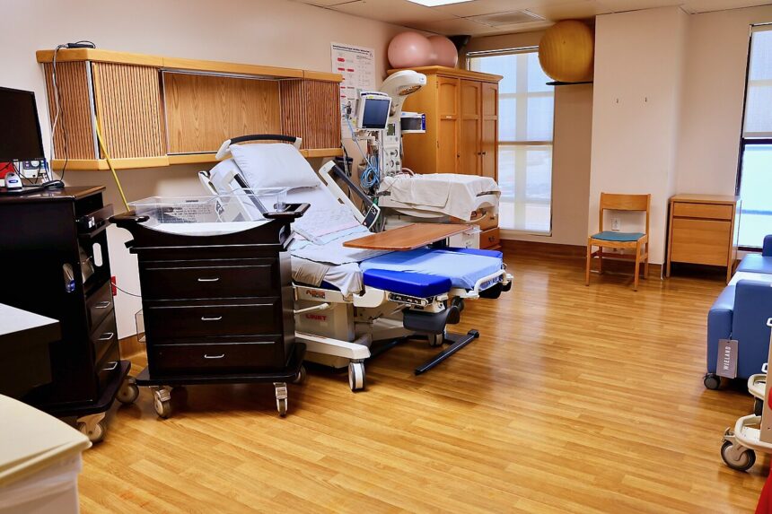 Hospital ward with vital sign monitoring equipment and nursing staff implementing early warning score protocol