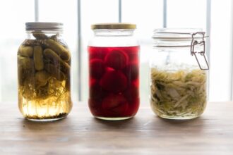 Variety of fermented foods including kimchi, sauerkraut, yogurt, and miso representing gut health and microbiome diversity
