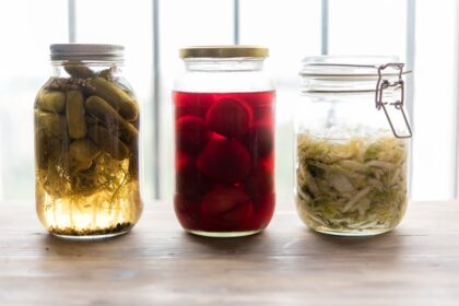 Variety of fermented foods including kimchi, sauerkraut, yogurt, and miso representing gut health and microbiome diversity
