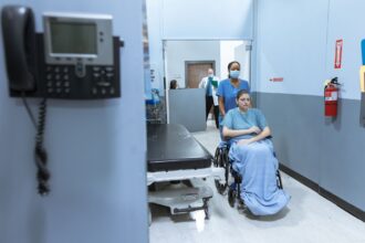 Hospital emergency department entrance illustrating emergency care access concerns