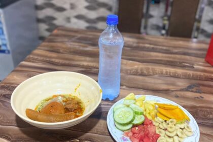 Fresh watermelon, cucumber, and cold beverages arranged on a table during summer heat