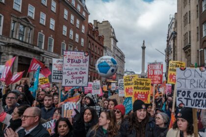 Healthcare professional examining NHS policies during industrial action dispute