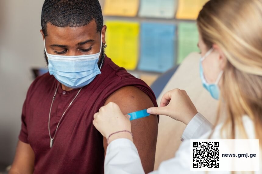 Healthcare professional reviewing vaccination guidelines and patient immunisation records