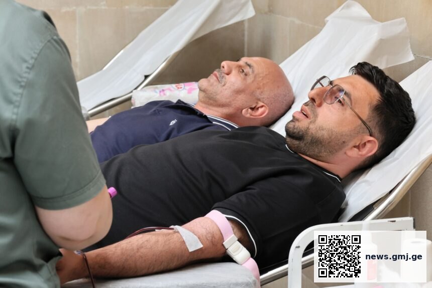 Medical professionals handling blood donation equipment in modern healthcare facility