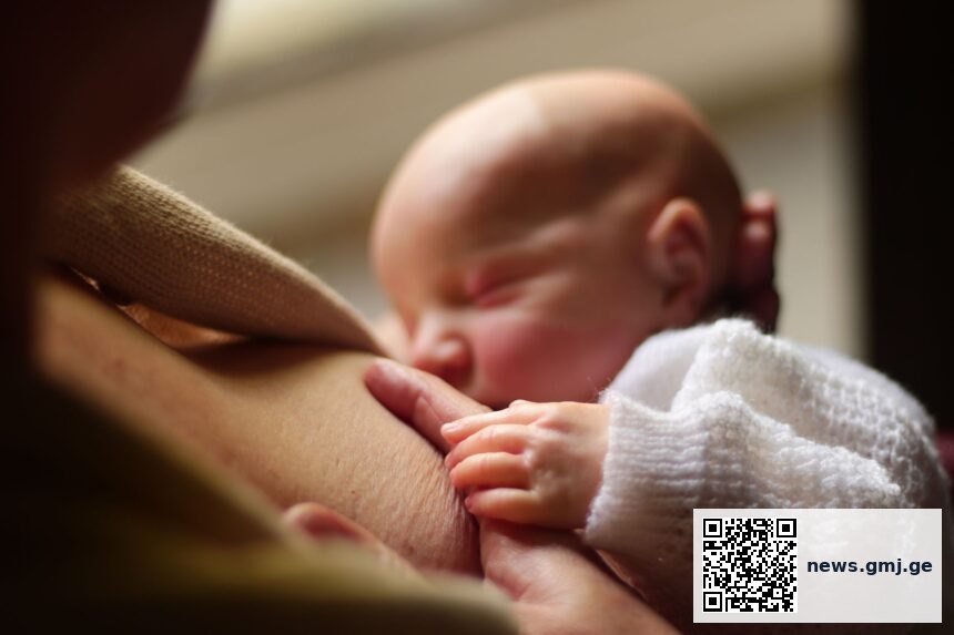 New mother struggling with breastfeeding in hospital setting
