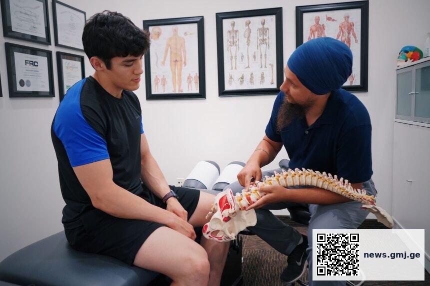 Senior adult performing supervised preoperative exercise program before spinal surgery