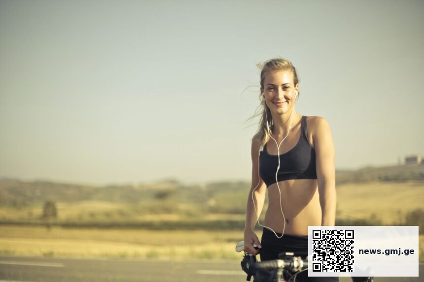 Cyclists exercising on stationary bikes with and without music; heart rate and lactate monitors visible